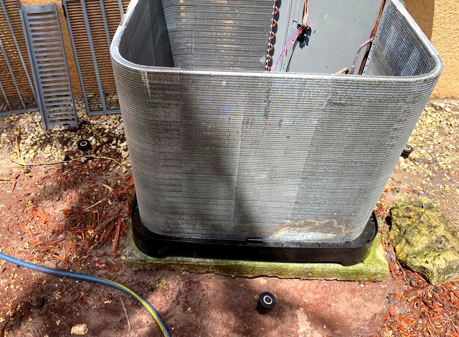 The same condenser coil after rinsing, fins open and clean.