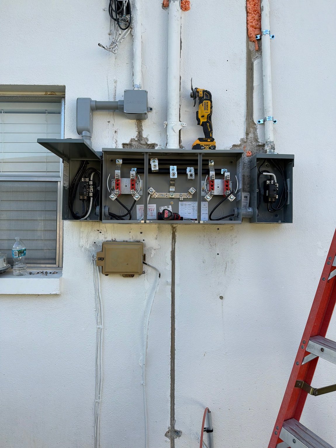 Meter stack opened on an exterior wall during a service equipment replacement.