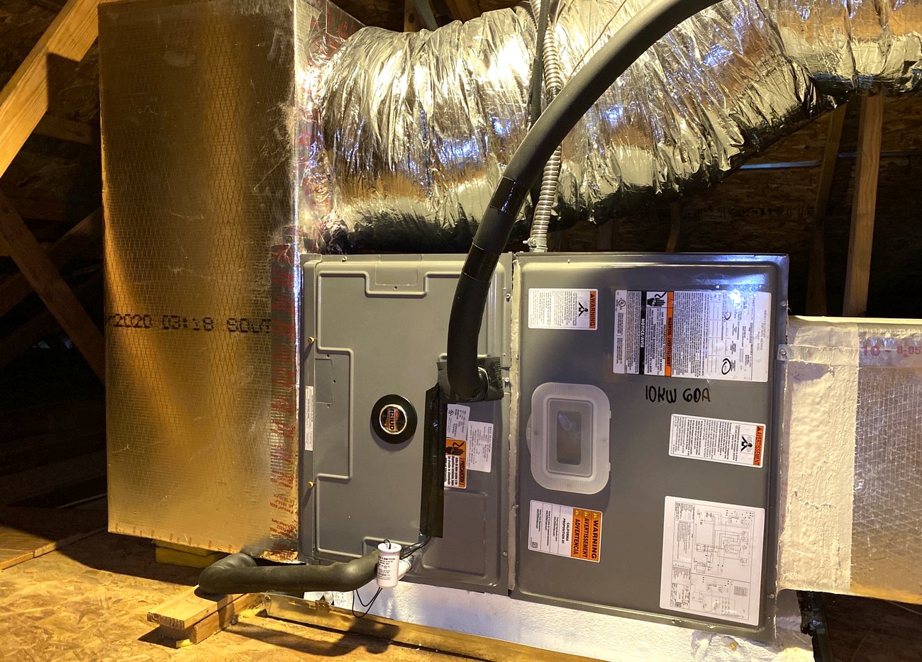 Attic air handler installation with flexible duct and a float switch at the pan.